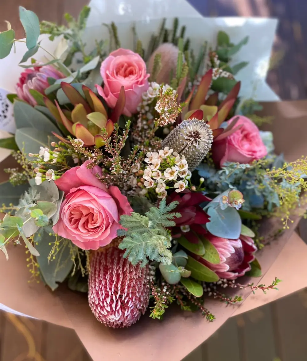 Custom bouquet of pink roses, proteas, banksia and succulents